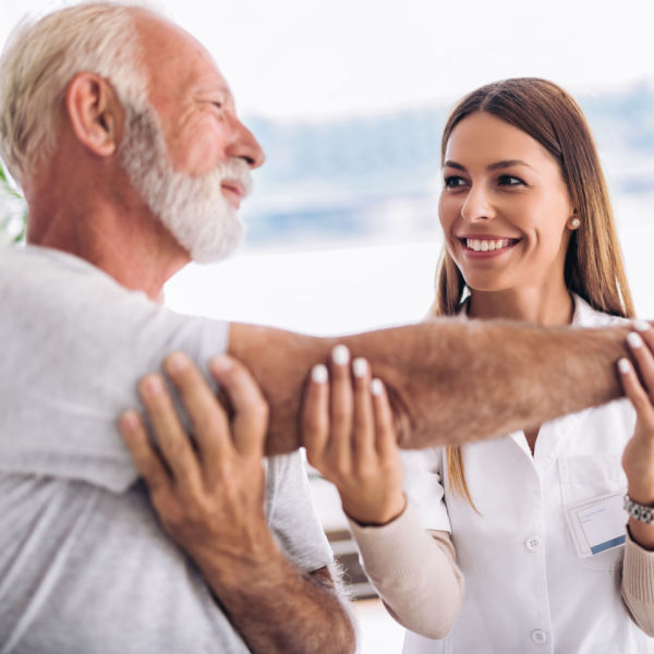 elderly man receiving chiropractic adjustment