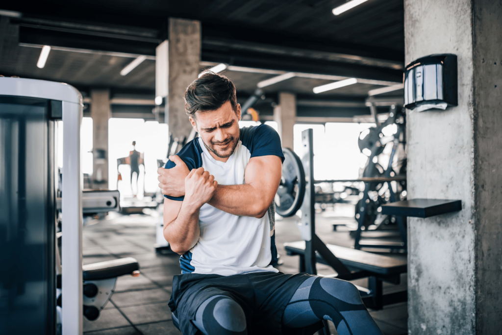 Man needing chiropractic treatment for sports injury in gym