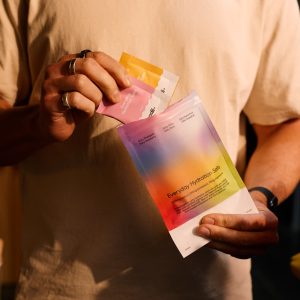 Person preparing berry flavoured electrolyte drink to support hydration magnesium intake and muscle function