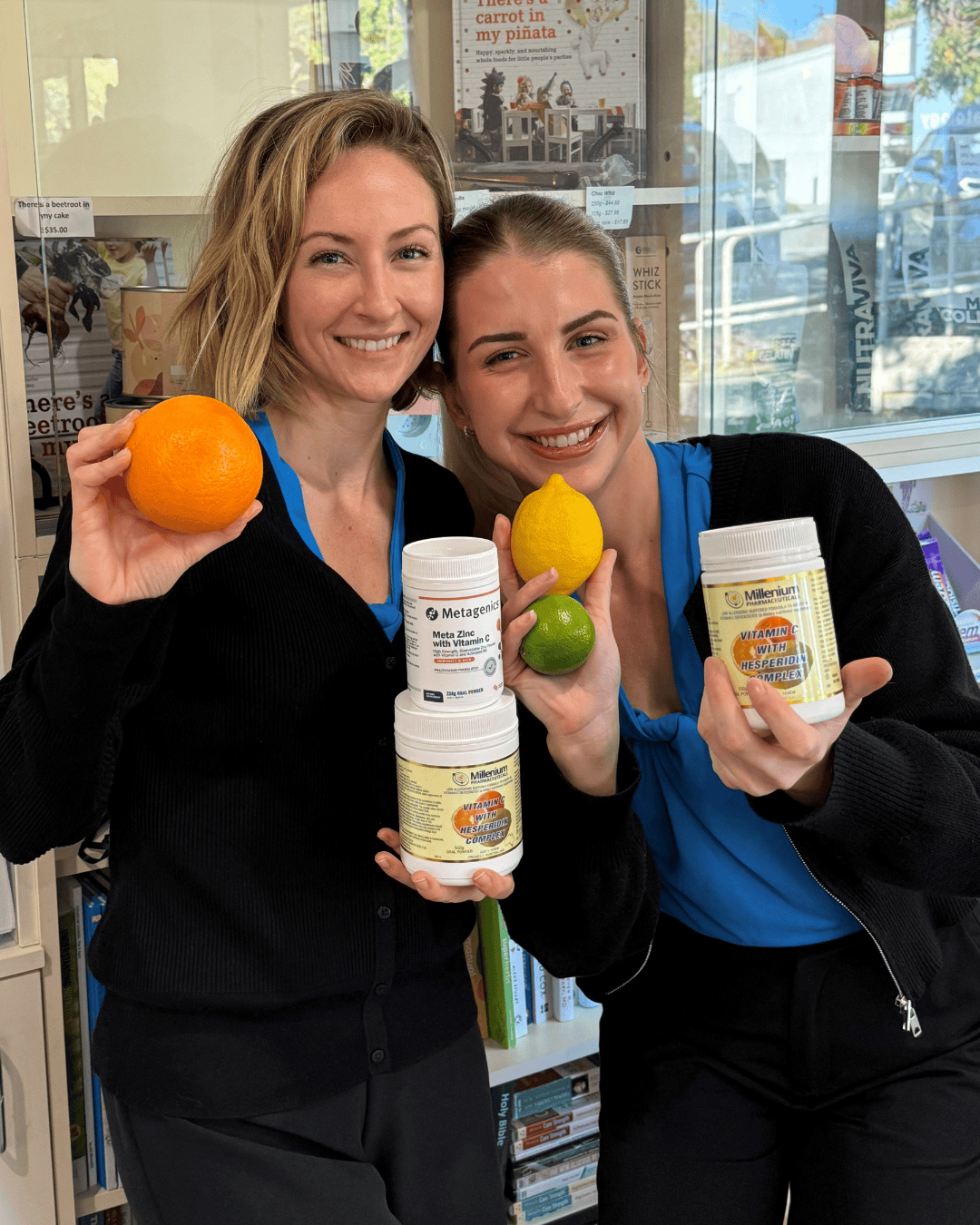 staff in wellness centre holding foods with vitamin c as well as vitamin c supplements
